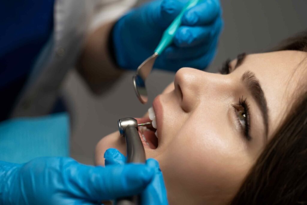 dentist in blue gloves filling the beautiful smiling woman